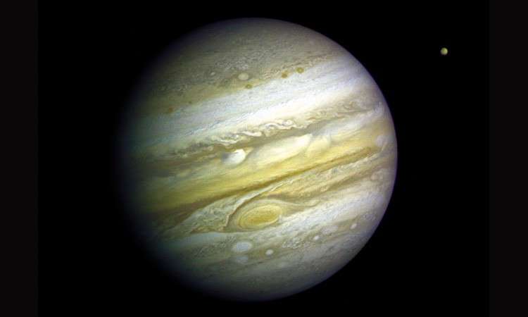 Jupiter et le satellite Io photographiés par la sonde Voyager en 1979. © Nasa