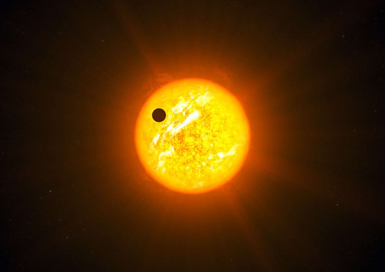 Une vue d'artiste d'une exoplanète en transit devant son étoile. © ESO, L. Calçada