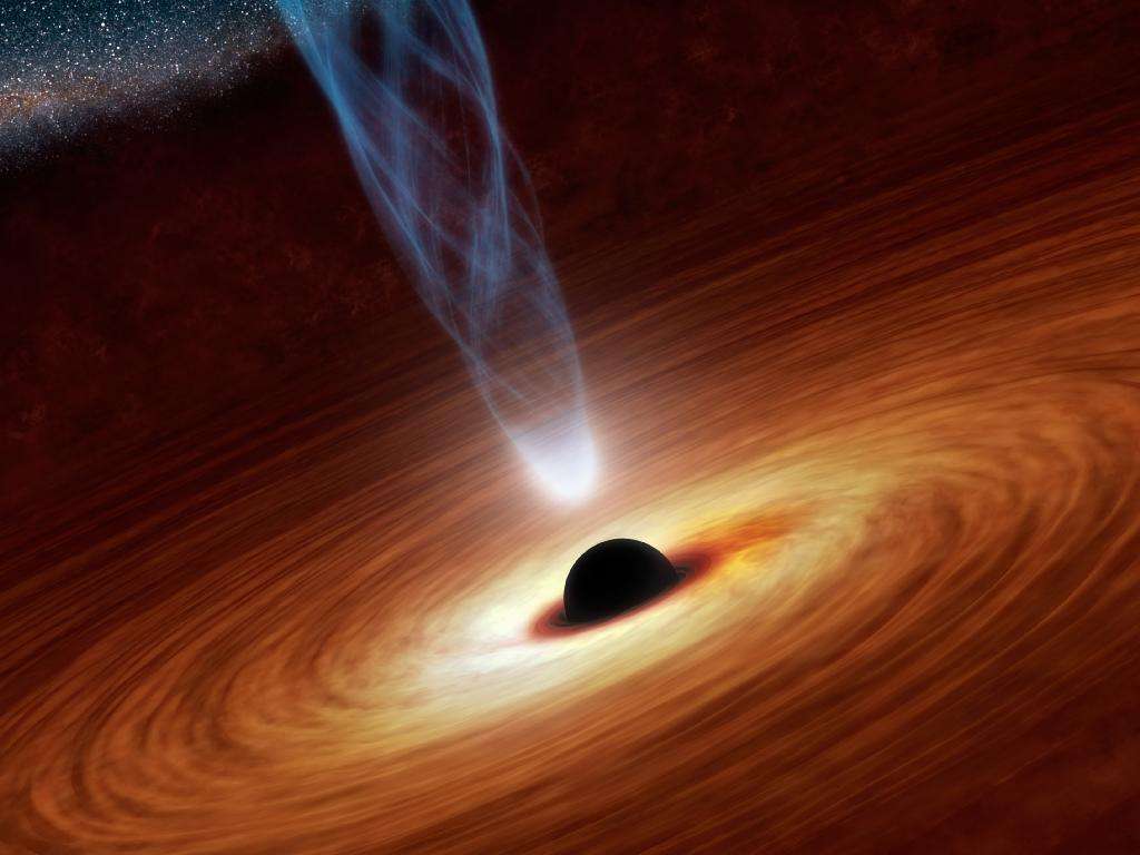 Une vue d'artiste d'un trou noir supermassif en rotation entouré d'un disque de matière. On voit aussi un jet de particules s'élevant du trou noir, générant des rayons X réfléchis par le disque. C'est la mesure de ce flux de rayons X réfléchis qui permet d'estimer la vitesse de rotation du trou noir. © Nasa