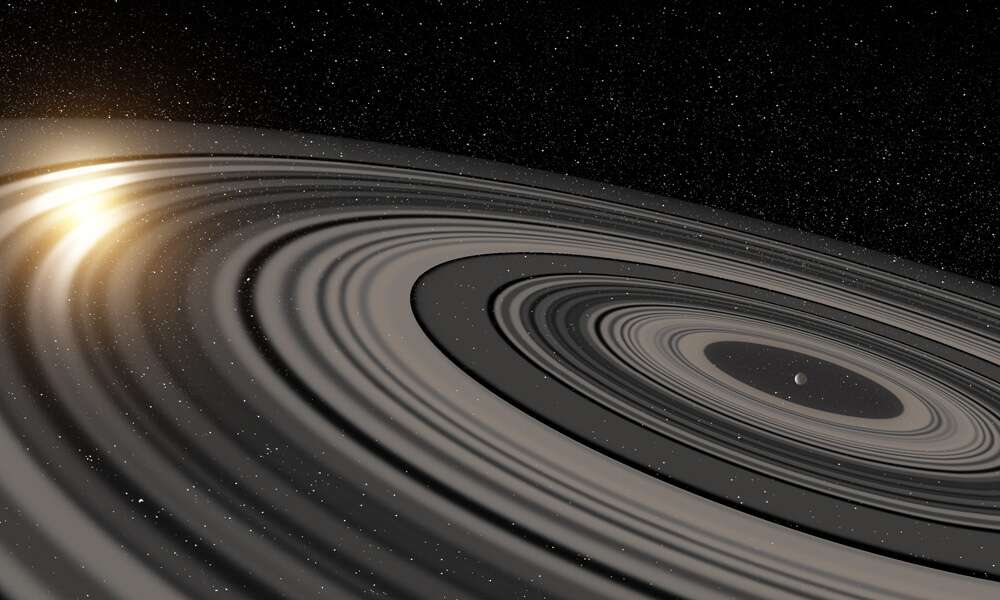 Illustration du vaste système d’anneaux qui entoure la possible super-Saturne ou naine brune J1407b. En passant devant la jeune étoile autour de laquelle elle gravite, la lumière de celle-ci est en partie occultée. © Ron Miller