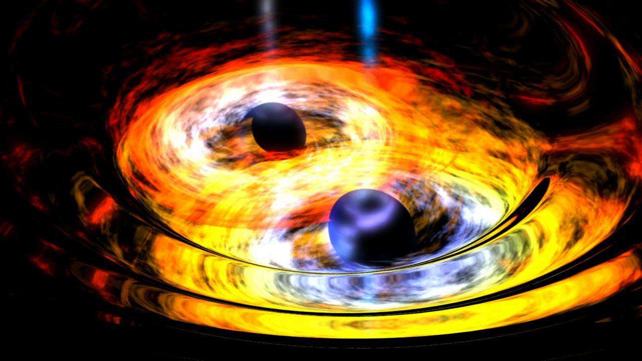 Deux trous noirs supermassifs avec les disques d'accrétion, en vue d’artiste. Les forces de marée déforment les horizons et les perturbations qu'elles induisent sur les disques sont violentes. Les trous noirs sont sur le point de fusionner, ce qui se traduira par une brusque augmentation de leurs émissions d'ondes gravitationnelles. La source détectée par Wise est probablement un tel objet astrophysique et, si c'est bien le cas, elle subira le même destin. © Nasa