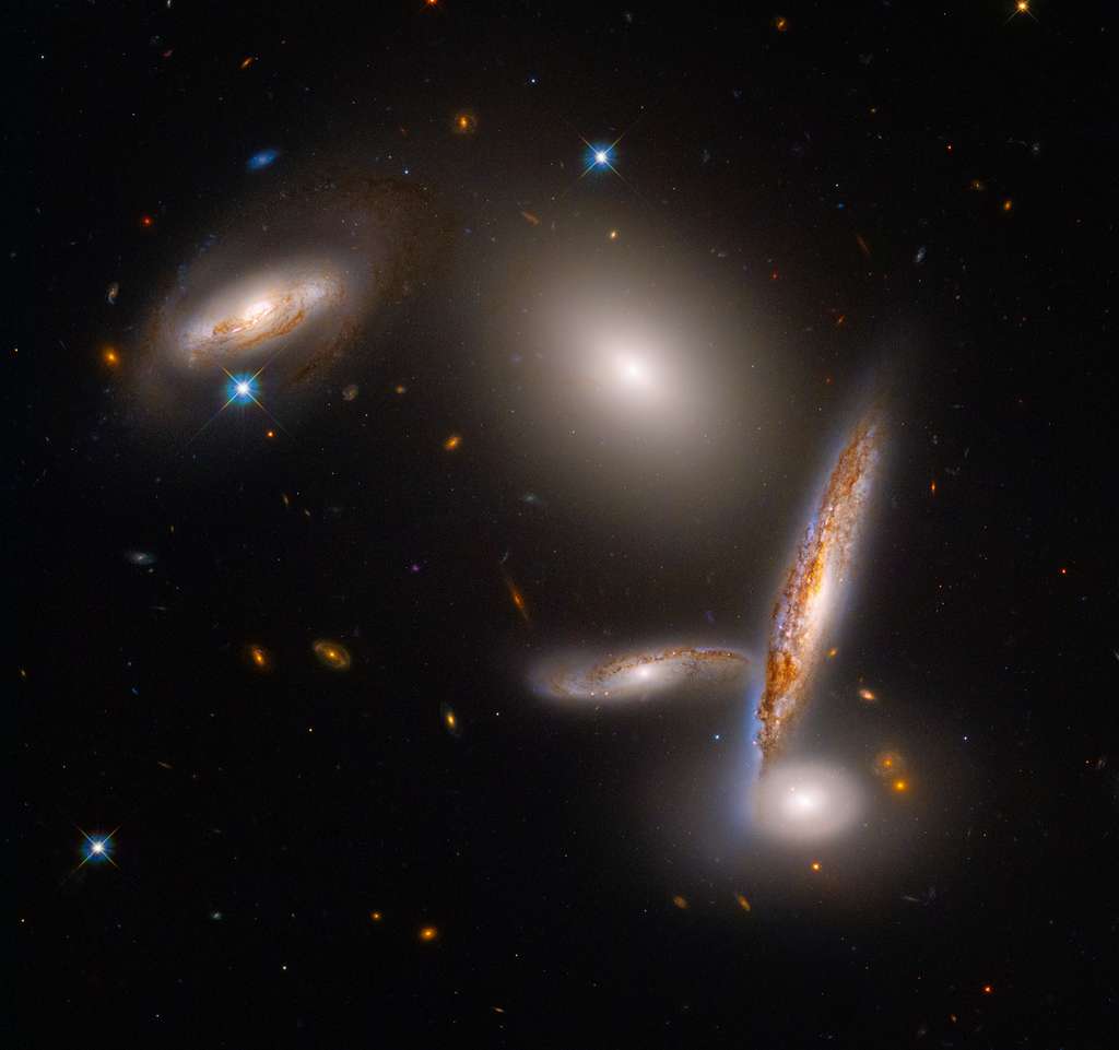 These five galaxies are trapped in a halo of dark matter, forcing them to approach each other until they collide.  Download image (28.6 Mb) for printing.  © NASA, ESA, STScI, Alyssa Pagan