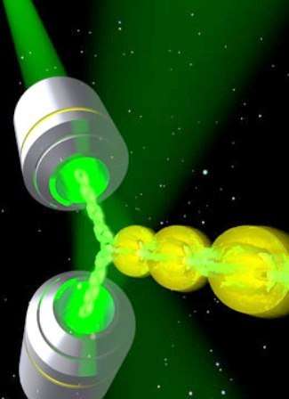 Un schéma illustrant le dispositif constituant un rayon tracteur. Deux faisceaux laser (en vert) sont combinés pour produire une onde lumineuse qui attire de petites sphères. © University of St Andrews