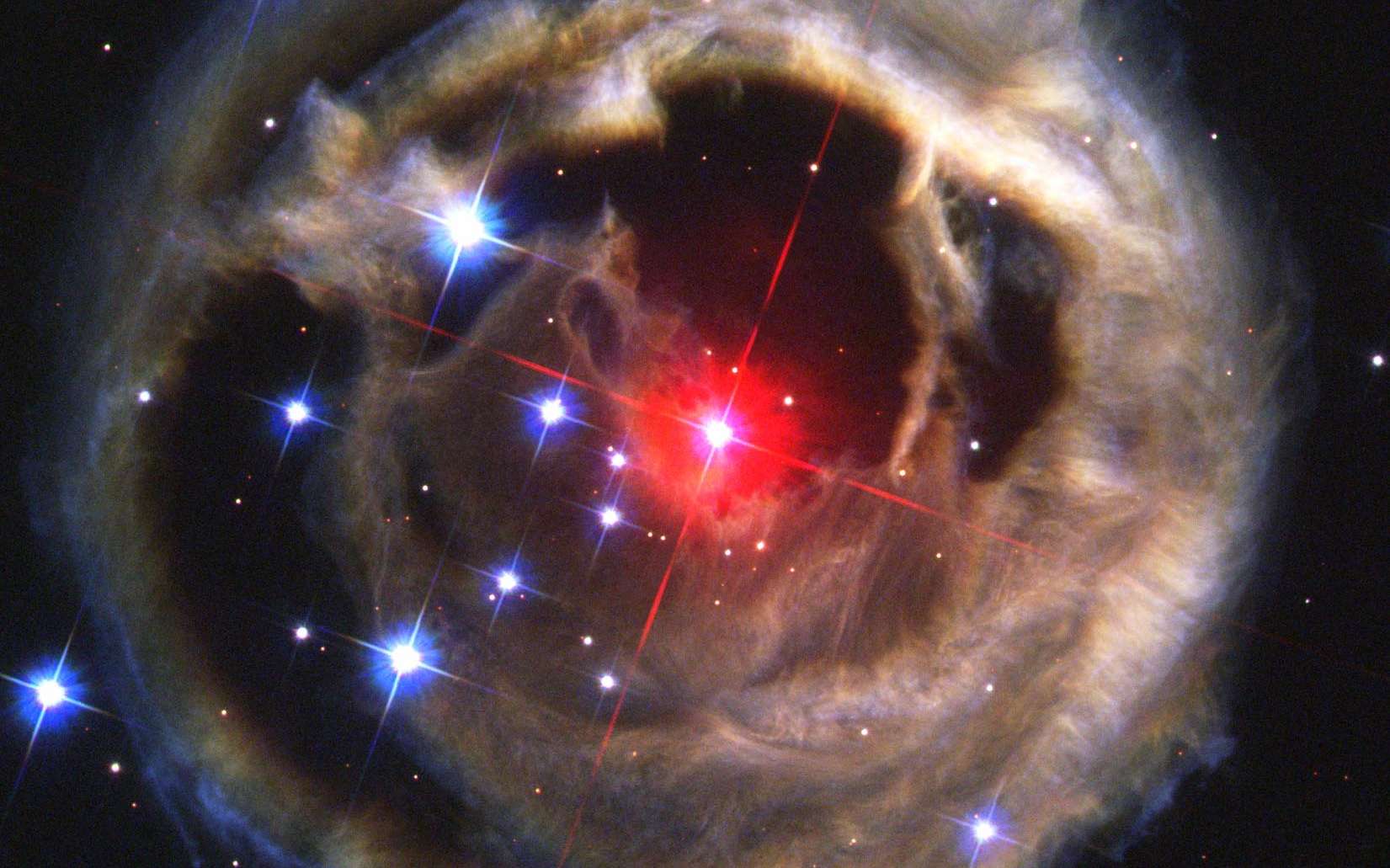 Observée par Hubble, l'étoile V838 Monocerotis serait le résultat de la fusion récente de deux naines rouges. On voit ici l'écho de lumière provoqué par un flash traversant les couches de poussières et de gaz éjectées par l'étoile. © Nasa, Esa