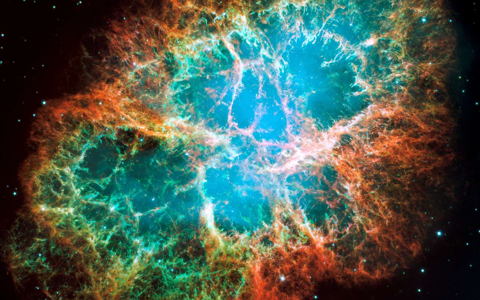 La nébuleuse du crabe, un nuage de débris en expansion de six années-lumière de diamètre provenant d'une explosion de supernova, héberge une étoile à neutrons tournant sur elle-même 30 fois par seconde et qui fait partie des pulsars les plus brillants du ciel aux longueurs d'onde des rayons X et radio. Cette composition d'images du télescope spatial Hubble révèle différents gaz expulsés lors de l'explosion: le bleu révèle l'oxygène neutre, le vert montre le soufre mono-ionisé et le rouge indique l'oxygène doublement ionisé. © Nasa, ESA, J. Hester et A. Loll (Arizona State University)