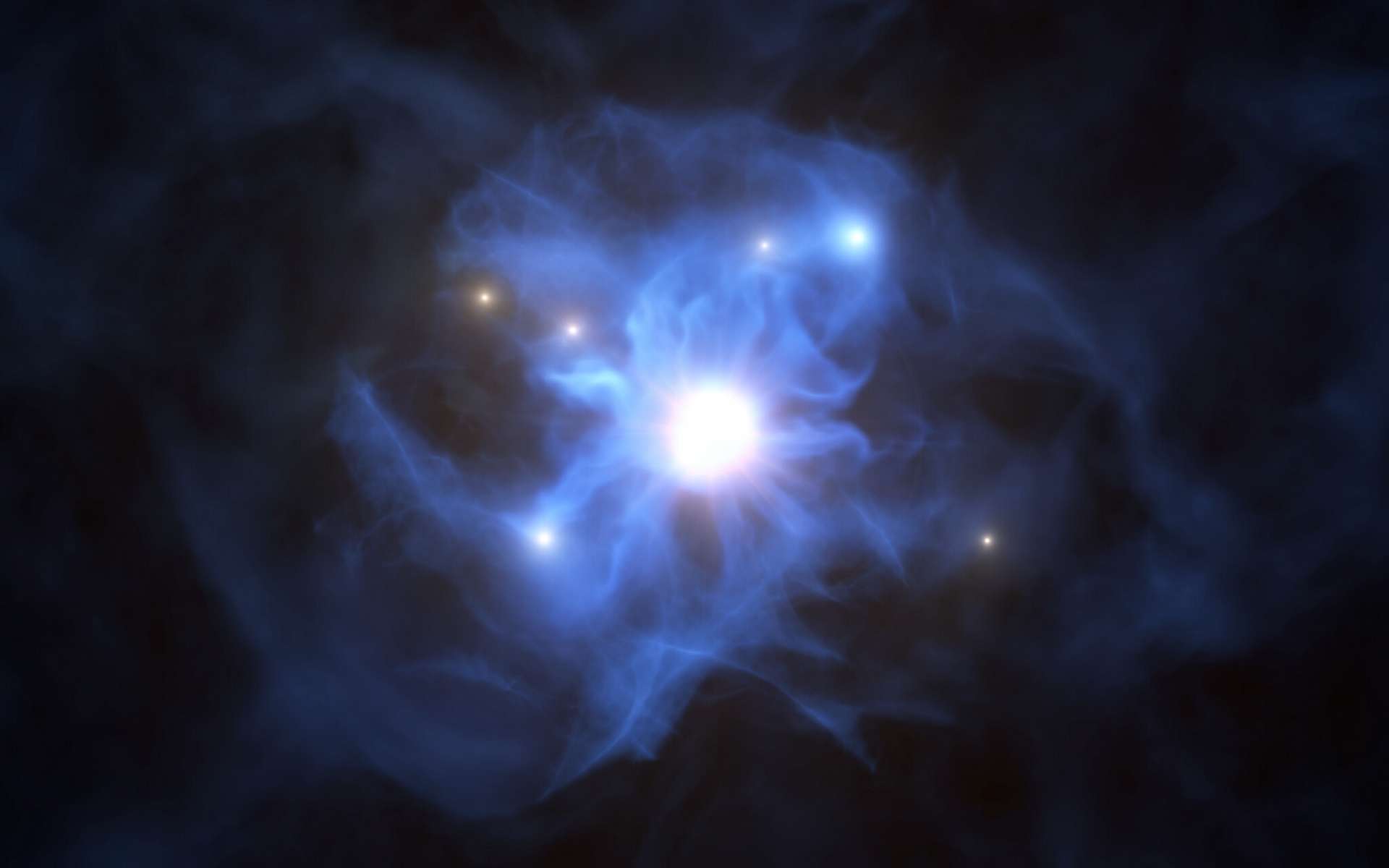 Grâce au Very Large Telescope (VLT) de l’ESO, les astronomes ont découvert six galaxies situées en périphérie d’un trou noir supermassif. C’est la toute première fois qu’un tel groupement est observé durant le premier milliard d’années de l’Univers. Sur cette vue d’artiste figurent le trou noir central ainsi que les galaxies piégées au sein de sa toile de gaz. Le trou noir et le disque qui l’entoure composent le quasar baptisé SDSS J103027.09+052455.0. Sa brillance augmente à mesure qu’il engouffre la matière qui l’entoure. © ESO/L. Calçada
