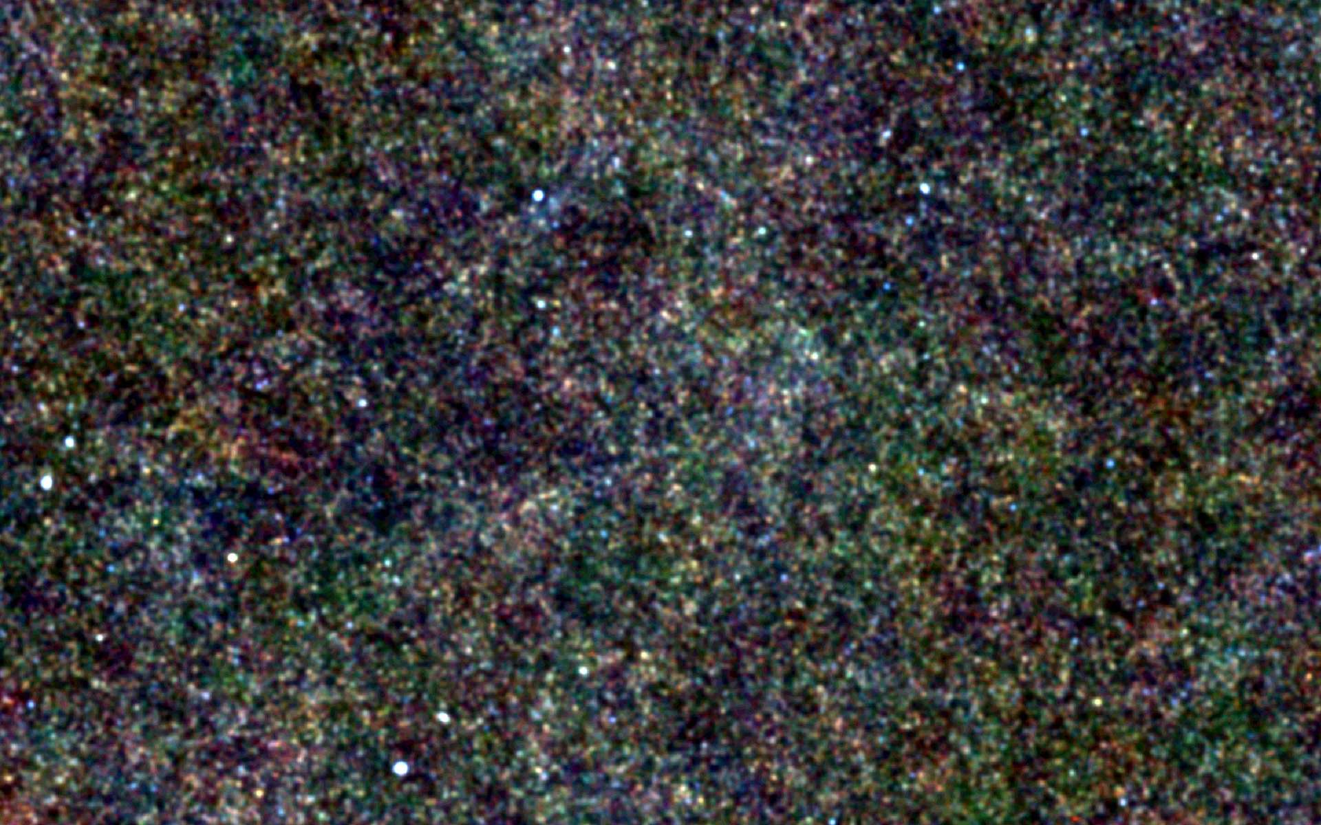 Le trou de Lockman est une région de la Voie lactée située dans la constellation de la Grande Ourse qui est presque libre de l'absorption des rayons X par le gaz d'hydrogène neutre. Il doit son nom à son découvreur, l'astronome Félix Lockman. Il a permis à Herschel d'observer des galaxies telles qu'elles étaient il y a 10 à 12 milliards d'années. On voit ici ces galaxies sous forme de points. © Esa & SPIRE consortium & Hermes consortium