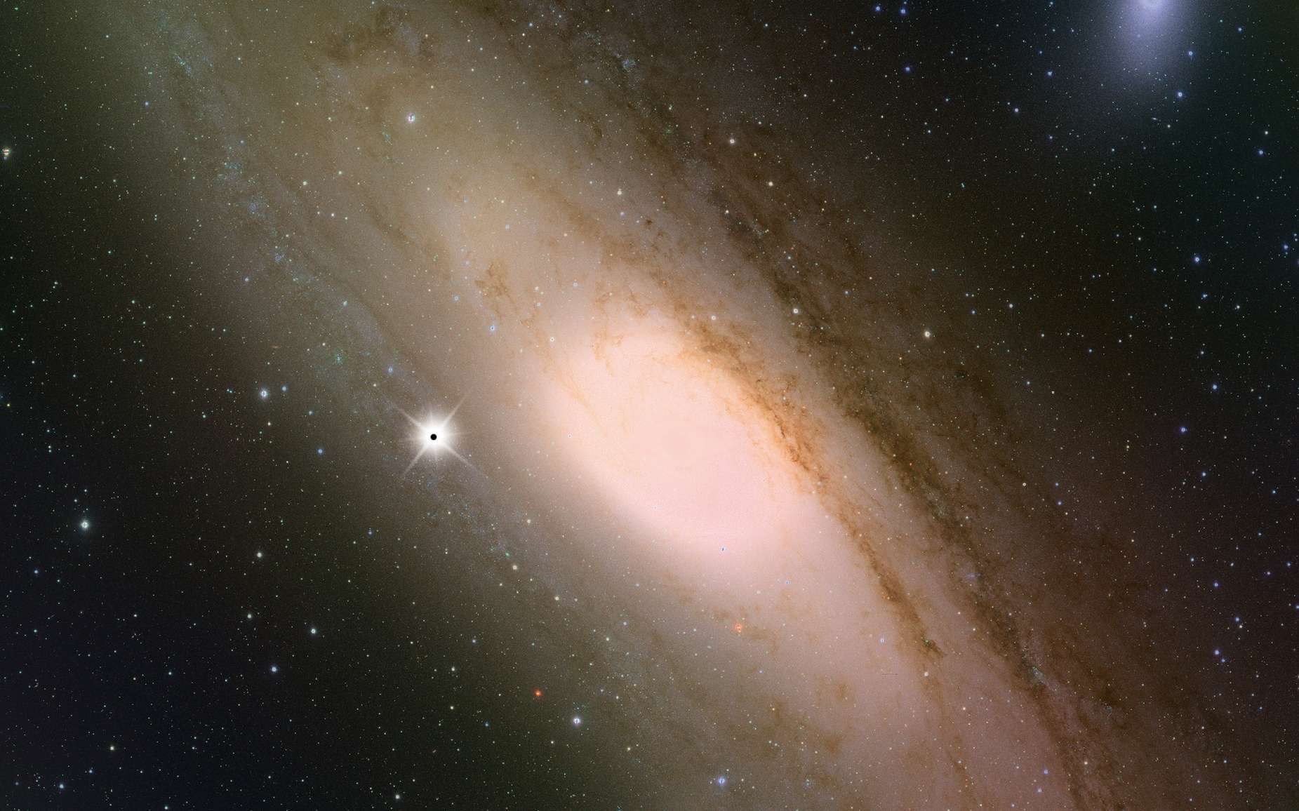 Un montage illustrant l'effet de microlentille gravitationnelle produit par un trou noir primordial sur une étoile de la galaxie d'Andromède. © Kavli IPMU
