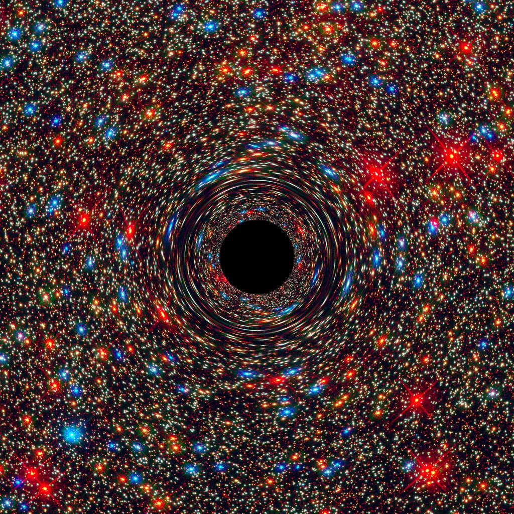 Image d’un trou noir supermassif au centre d’une galaxie simulée par ordinateur. Le rond noir figure l’horizon des événements, limite au-delà de laquelle toute matière ne peut plus s’échapper. Plus la masse de ce puit gravitationnel est grande, plus l’espace et le temps sont déformés, ce qui produit cet effet de miroir déformant sur les étoiles à l’arrière-plan. © Nasa, Esa, C.-P. Ma (University of California, Berkeley), J. Thomas (Max Planck Institute for Extraterrestrial Physics, Garching)
