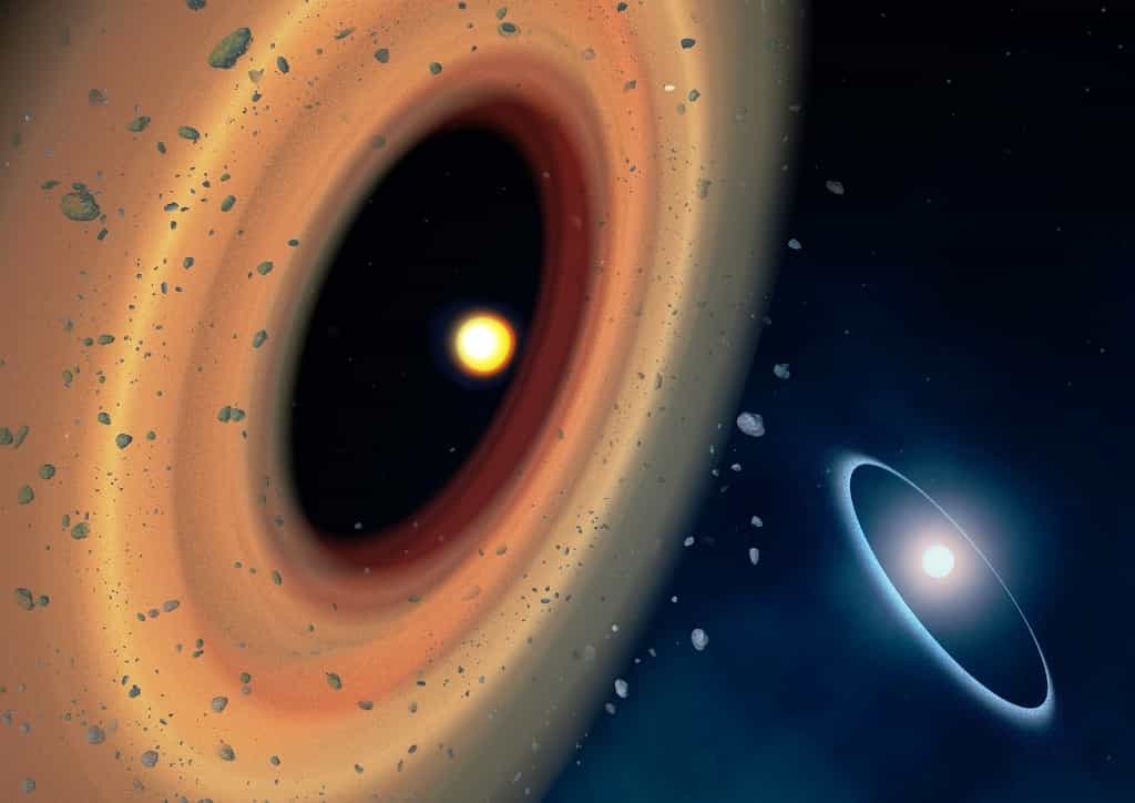 Vue d'artiste du système Fomalhaut. Le nouvel anneau de comètes autour de Fomalhaut C est montré à gauche. L'autre anneau autour de Fomalhaut A est montré au loin à droite. L'anneau autour de Fomalhaut A est décentré : c'est la signature que les orbites dans l'anneau sont elliptiques. Selon le scénario des astronomes, la cause pourrait être l'interaction gravitationnelle avec Fomalhaut A. © CNRS, Amanda Smith