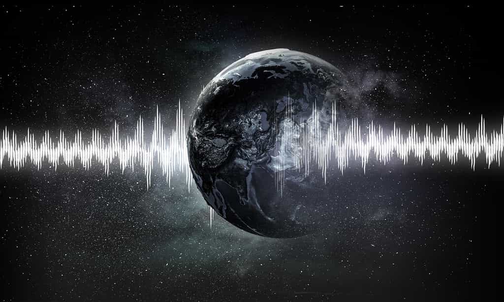 Une représentation visuelle d'une onde sonore traverse la Terre venue de vue l'espace. © Sergey Nivens, Adobe Stock