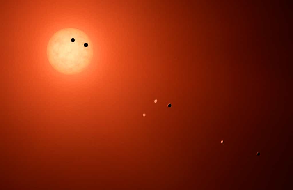 Illustration de la naine rouge ultrafroide Trappist-1 et de ses sept planètes rocheuses. © Nasa, JPL-Caltech, R. Hurt (IPAC)