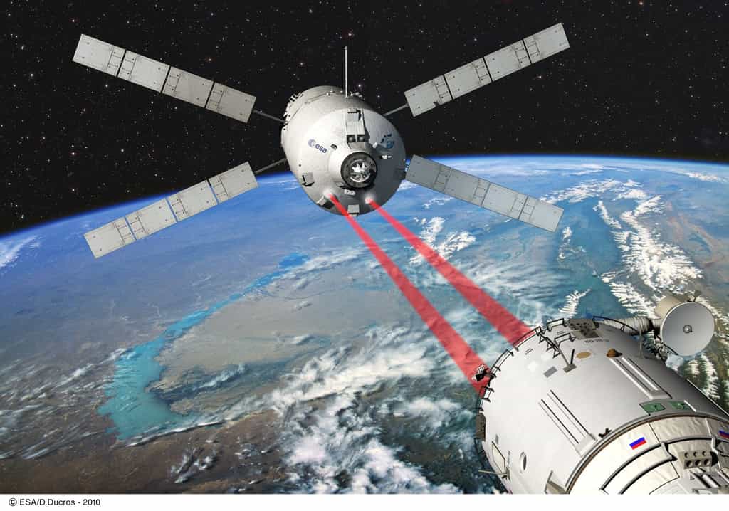 Une vue d'artiste de l'approche de l'ATV vers le module russe Zvezda de l'ISS. Elle montre deux faisceaux laser qui servent à contrôler le positionnement et la distance par rapport à la Station. Le système comprend en fait deux vidéomètres qui, dans les 300 derniers mètres, reconnaissent des réflecteurs installés sur l'ISS, et deux télégoniomètres, qui envoient des pulsations laser sur ces mêmes réflecteurs, et déterminent la distance et donnent une deuxième mesure de la direction de la trajectoire. © Esa/Ducros-2010