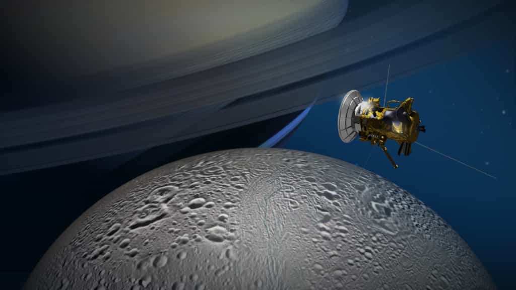 Une vue d'artiste de Cassini entre Saturne et Encelade. © Nasa