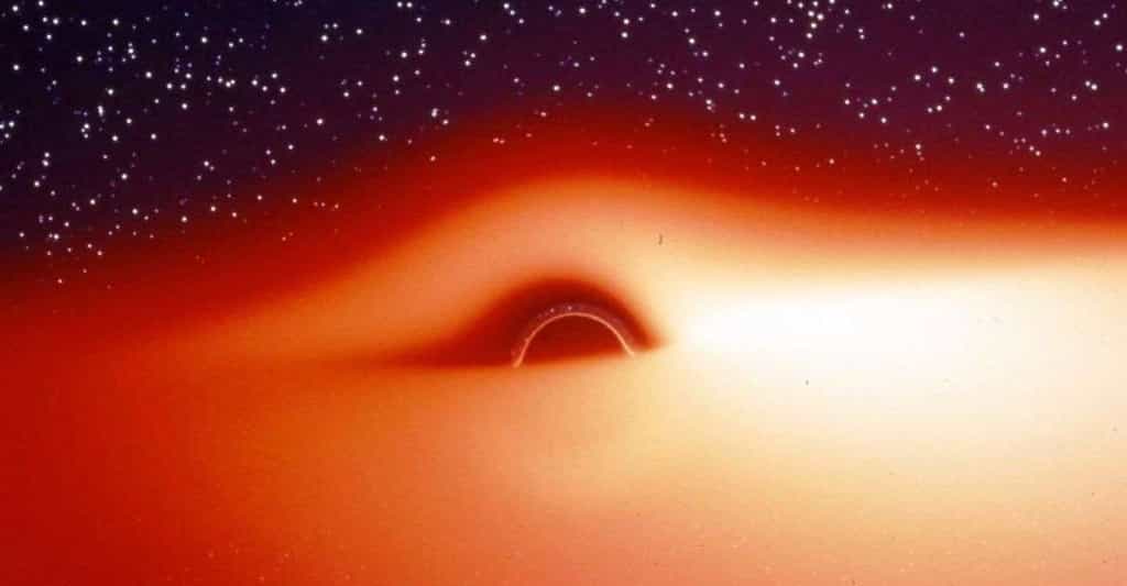 Le champ de gravitation d'un trou noir entouré d'un disque d'accrétion chaud et lumineux déforme fortement l'image de ce disque. Cette image, extraite d'une simulation, montre ce que verrait un observateur s'approchant de l'astre compact selon une direction légèrement inclinée au-dessus du disque d'accrétion. La partie du disque située derrière le trou noir semble tordue à 90° et devient visible. Jean-Pierre Luminet a fait la première simulation de ces images en 1979. © Jean-Pierre Luminet, Jean-Alain Marck 