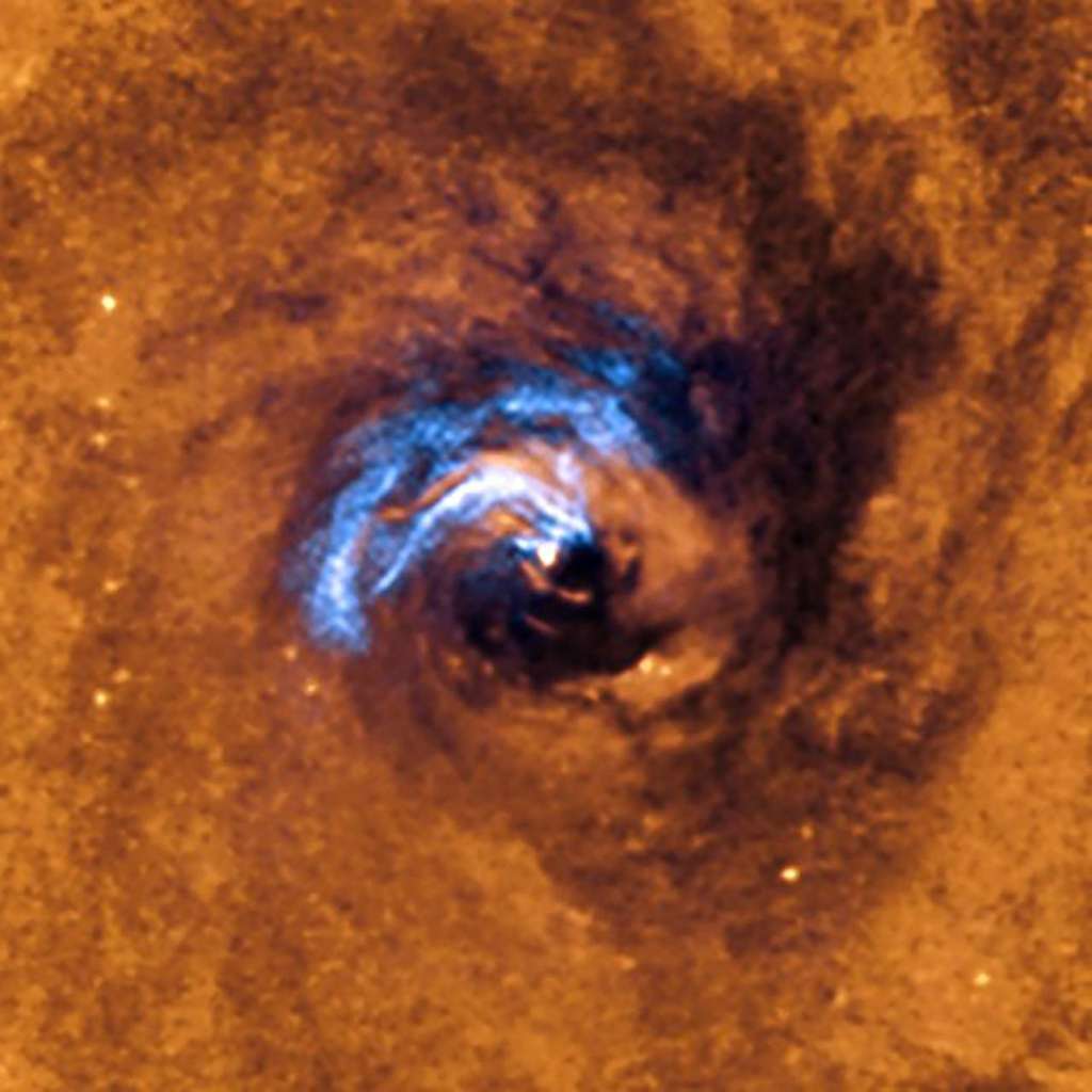 Processus d'ingestion de filaments de poussière par le trou noir supermassif de NGC 1566. © ESO, IAC