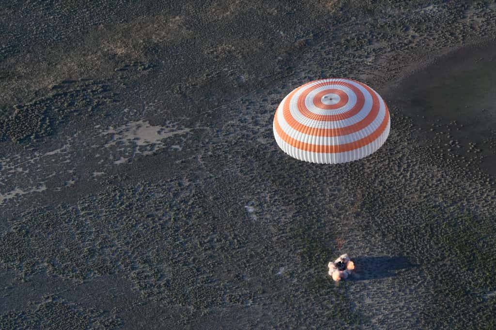 Retour du français Thomas Pesquet à bord d'une capsule Soyouz (juin 2017) après une descente sous parachute. On aperçoit les rétrofusées en action quelques dizaines de centimètres avant l'atterrissage de la capsule. © S. Corvaja, ESA