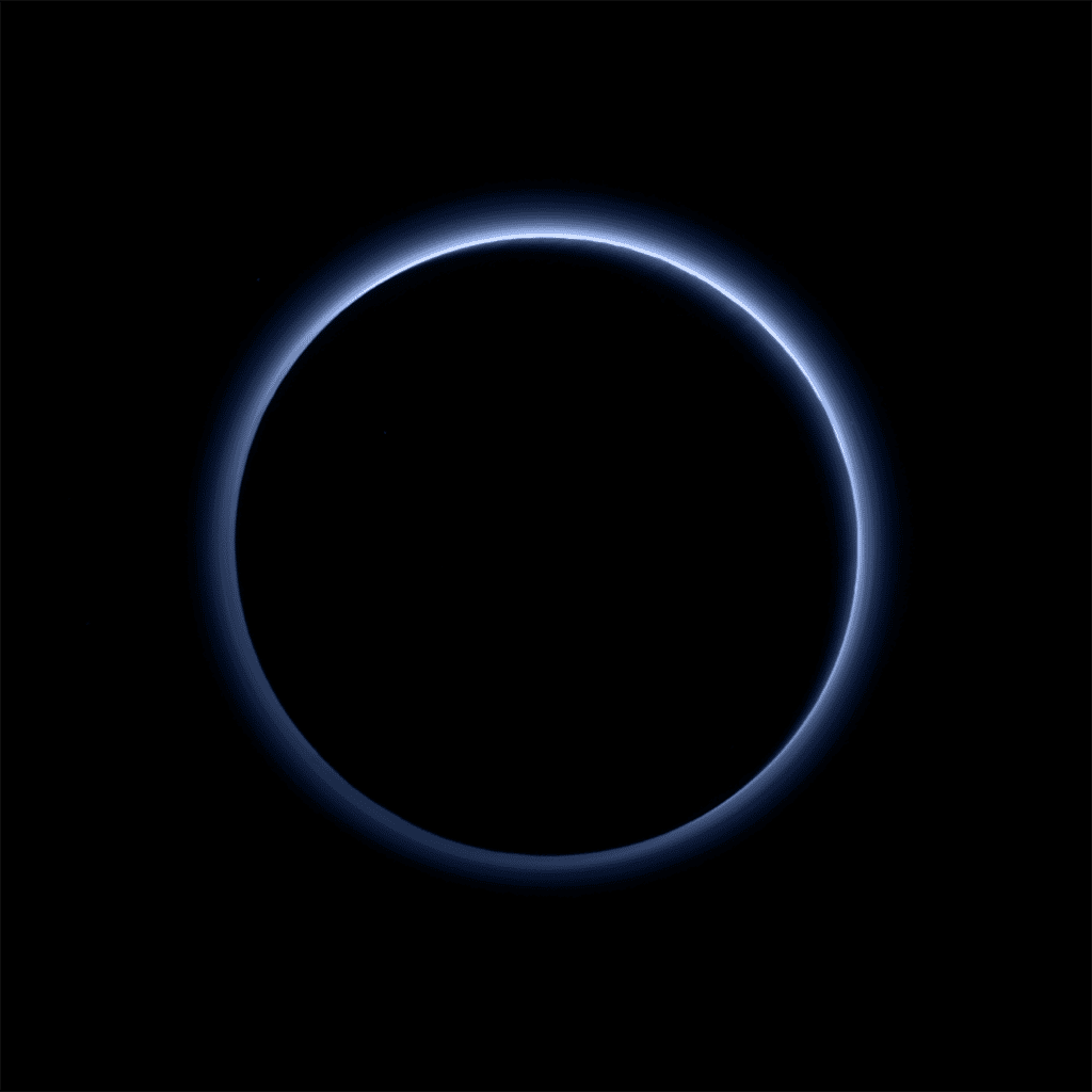 Après le survol de la planète naine, jusqu’à 12.500 km de sa surface, l’instrument Ralph/MVIC (<em>Multispectral Visible Imaging Camera</em>) l’a imagée en contre-jour. Surprise, le ciel est bleu ! On distingue également sur le cliché les reliefs de Pluton et les empilements de couches de brume. © Nasa, SwRI, JHUAPL