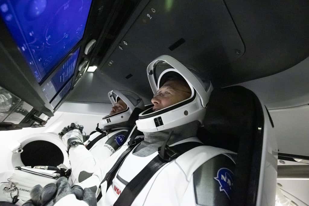 Les astronautes Bob Behnken et Doug Hurley, à bord du Crew Dragon et son cockpit futuriste, devront attendre quelques jours de plus avant de décoller à destination de la Station spatiale internationale. © SpaceX, Nasa