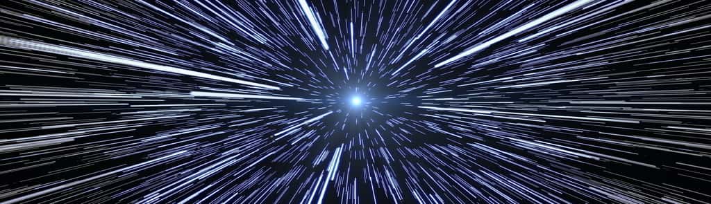 En science-fiction, l'entrée dans l'hyperespace s'accompagne souvent d'une apparence « étirée » des étoiles, puis de l'apparition d'un tunnel. © elipsefx, Adobe Stock