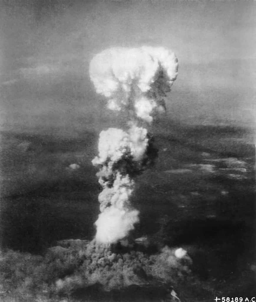 Le champignon atomique de la bombe <em>Little Boy</em> au-dessus de la province d'Hiroshima au Japon en 1945 tel que rapporté par les forces armées américaines et l'US Air Force. © George R. Caron, <em>Wikimedia Commons</em>. Domaine public