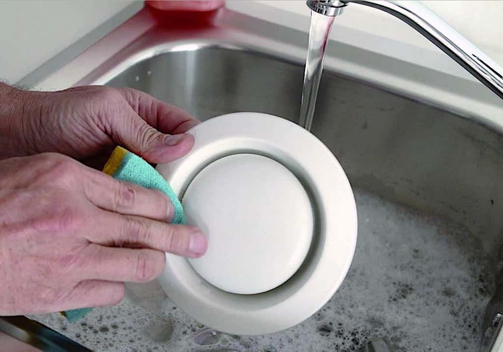 Remplissez le lavabo d’eau additionnée de liquide vaisselle et lavez la bouche d’extraction avec une éponge. Rincez ensuite à l’eau claire et faites sécher. © BC Tech Ventilation