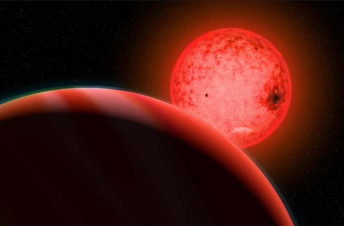 Vue d'artiste d'une grande planète géante gazeuse en orbite autour d'une petite étoile naine rouge appelée TOI-5205. © Image de Katherine Cain, avec l'aimable autorisation de la <em>Carnegie Institution for Science</em>.