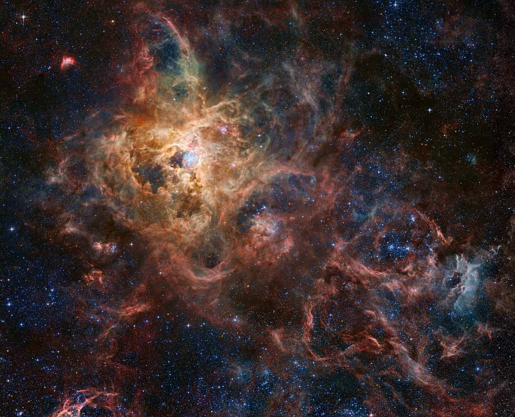 Assemblage et traitement par Robert Gendler des images de la nébuleuse de la Tarentule, aka 30 Doradus, prises par Hubble, le VLT, le JWST et des astronomes amateurs. Si <em>« la nébuleuse de la Tarentule était à la place de la nébuleuse d'Orion dans le ciel terrestre, elle couvrirait la moitié du ciel ! »</em>, explique le site Apod qui l'a publié. © <em>Hubble Tarantula Treasury, European Southern Observatory, James Webb Space Telescope</em>, Amateur Sources et traitement : Robert Gendler, <em>via</em> Apod (Nasa)