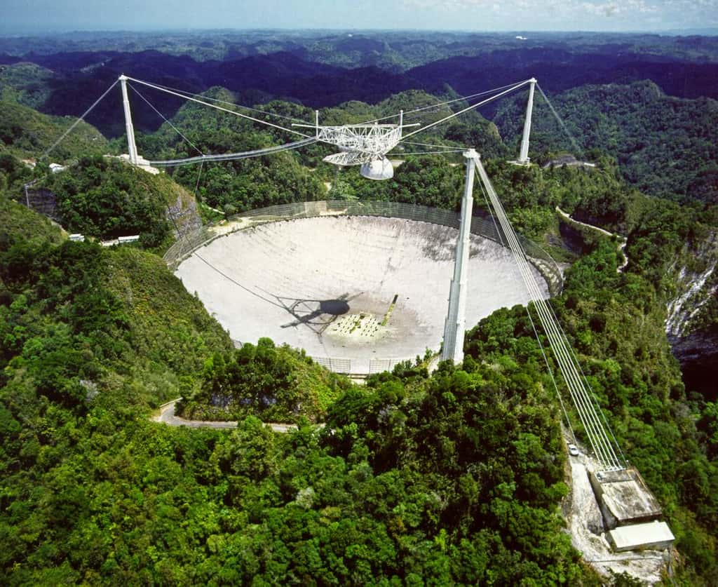 Le message d'Arecibo est un message radio qui a été émis vers l'amas globulaire M13 en 1974. Le radiotélescope utilisé alors, visible sur cette image, est situé sur la côte nord de l’île de Porto Rico. Le diamètre de l'antenne principale est de 305 mètres. © <em>Durham University</em>