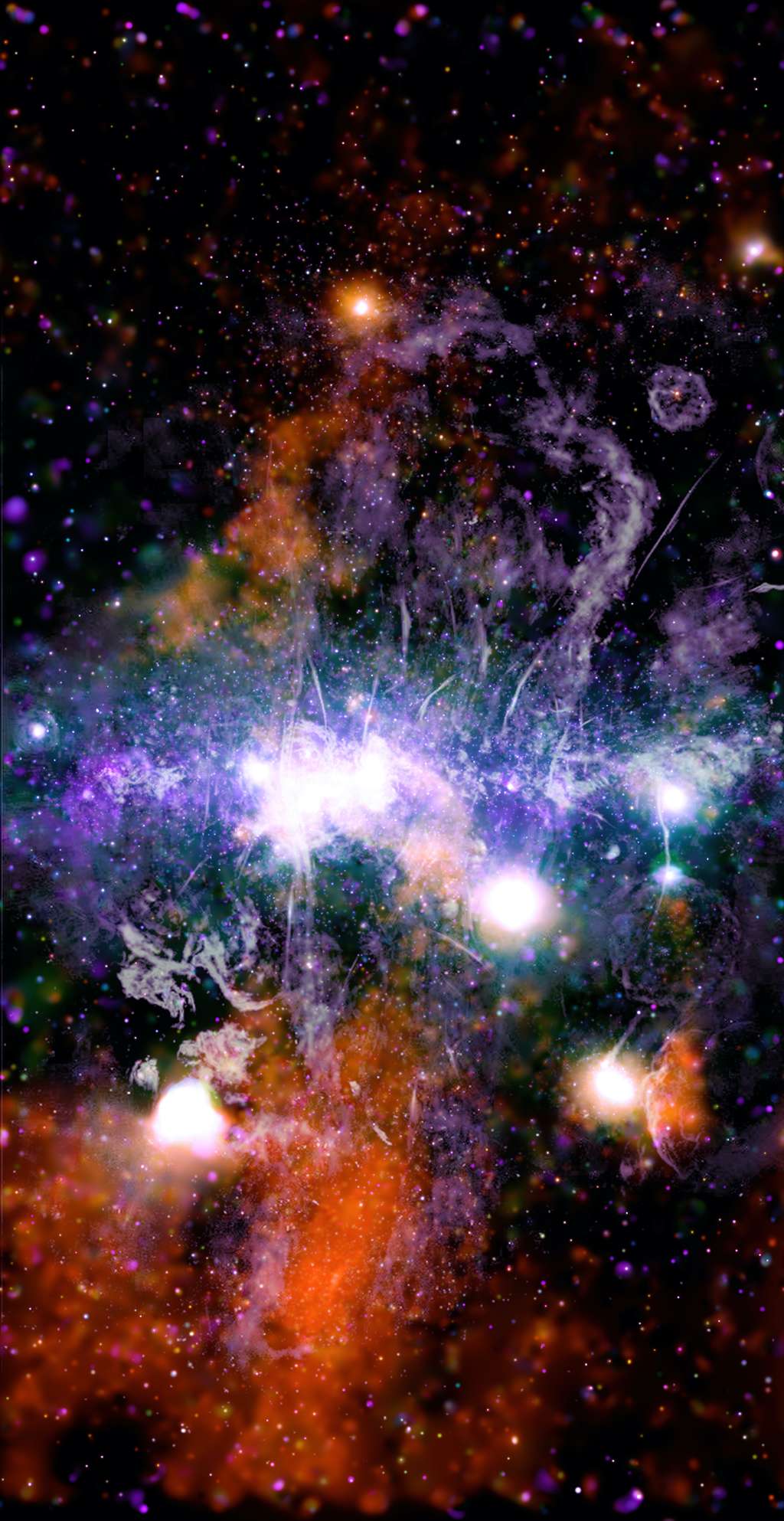 Sur cette magnifique image du cœur de la Voie lactée, les régions révélées aux rayons X de Chandra sont en orange, en vert, en bleu et en violet, selon les énergies des rayons X, et les données radio de MeerKAT sont affichées en lilas et en gris. © X-ray : Nasa, CXC, UMass, Q.D. Wang ; Radio : NRF, SARAO, MeerKAT