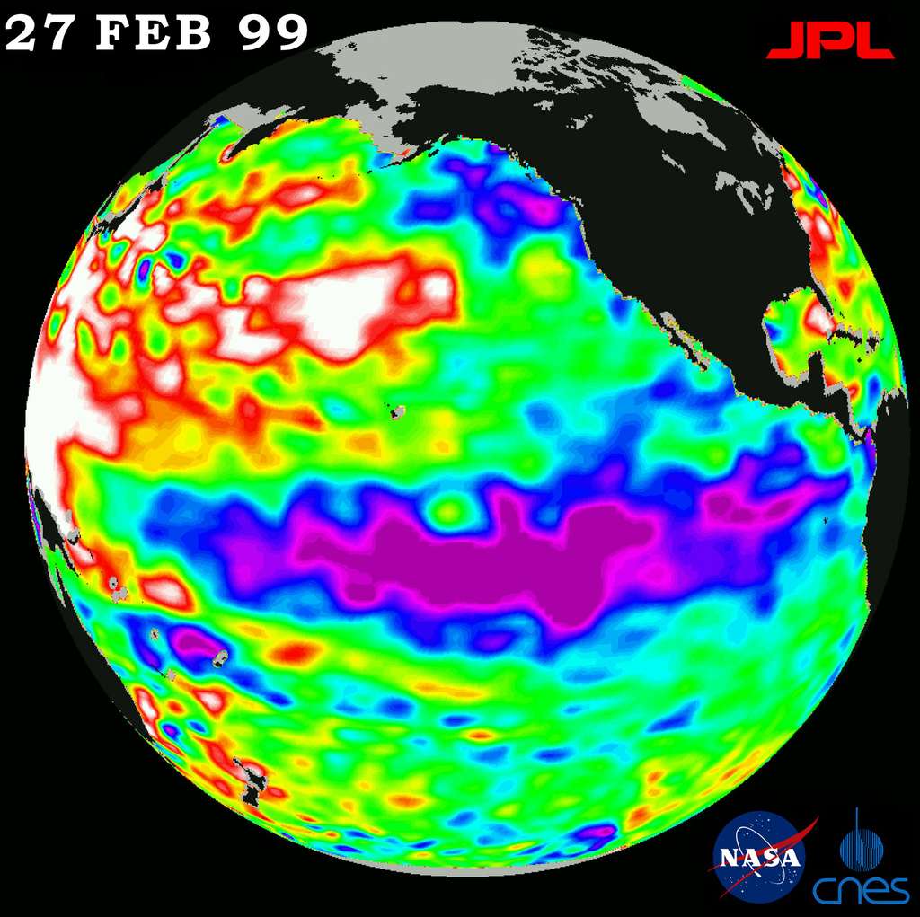 La Niña observée par le satelliteTopex-Poseidon en février 1999. Les couleurs indiquent le niveau de la mer par rapport à la moyenne, donc également la température. Les zones froides sont associées à un niveau plus bas. On les voit ici représentées en bleu et en mauve, à l'ouest du Pacifique, tandis que des eaux chaudes (en jaune et rouge) circulent à l'est, du côté de l'Australie. © Nasa, JPL