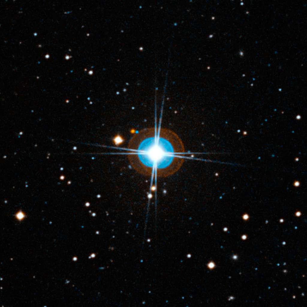 Gros plan autour de HD 10180. Comme la précédente, l'image a été créée à partir de photographies prises avec des filtres rouge et bleu. Les halos bleu et orange autour de l'étoile, et les huit pointes de lumière sont des artefacts. Le remarquable système planétaire autour de cette étoile est beaucoup trop proche d'elle pour être visible. Crédit : ESO, <em>Digitized Sky Survey</em> 2-Davide De Martin