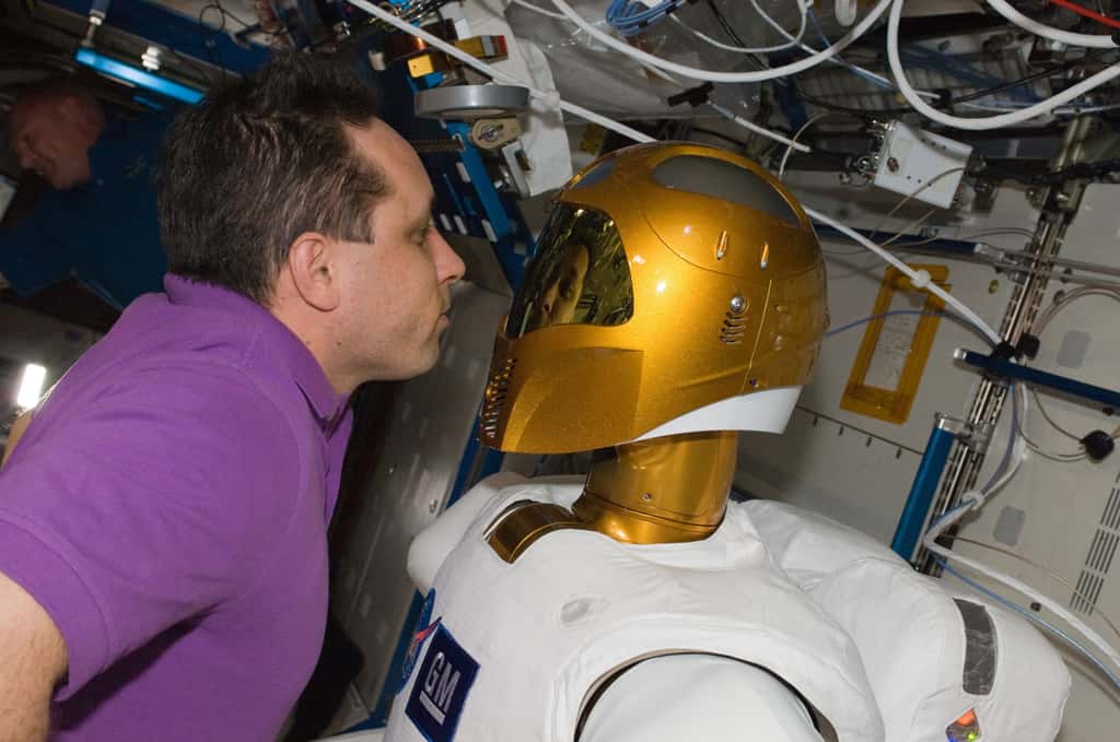 Le cosmonaute Anton Shkaplerov devant Robonaut 2 et son casque inspiré du personnage de Boba Fett de la saga <em>Star Wars</em>. © Nasa