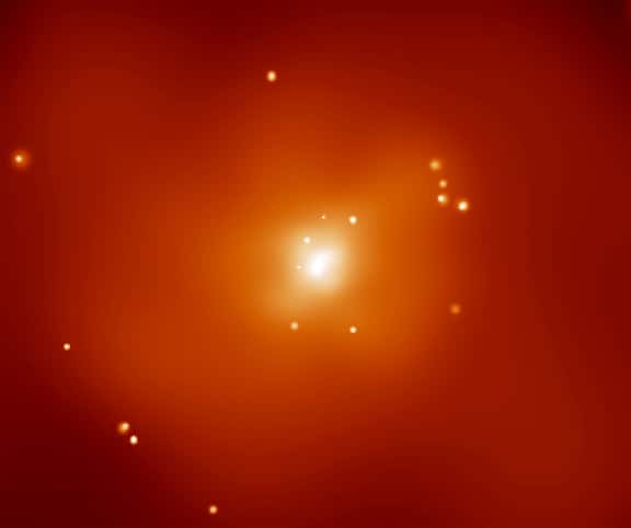 La galaxie NGC 720 est située à environ 80 millions d'années-lumière en direction de la constellation de la Baleine (<em>Cetus</em> en latin). Sur cette image prise par Chandra, cette galaxie elliptique apparaît clairement enveloppée d'un nuage de gaz émettant des rayons X. Visible sur cette image en fausses couleurs, la température extrême du gaz, environ 7 millions de degrés, rend impossible, en se basant sur la loi de Newton, le confinement du nuage à proximité de NGC 720 grâce à la seule gravité des étoiles visibles de la galaxie. Ce nuage est souvent présenté comme une preuve solide de la présence de matière noire entourant NGC 720 car son influence gravitationnelle peut empêcher le nuage de gaz chaud de s'échapper. La théorie Mond semble désormais fournir elle aussi une bonne description du comportement de ce nuage. © D. Buote (UC Irvine) <em>et al.</em>, CXC, Nasa