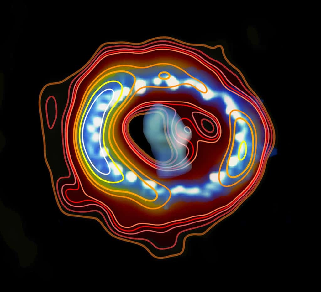 Les astronomes ont superposé une image radio (lignes colorées) avec une photographie de la supernova SN 1987a prise par le télescope Hubble (visible au bas de cet article). Le résultat obtenu leur a permis de prédire l'existence d'un pulsar au centre de la supernova, et non pas d'un trou noir comme on l'imaginait. © Icrar, Nasa, Esa
