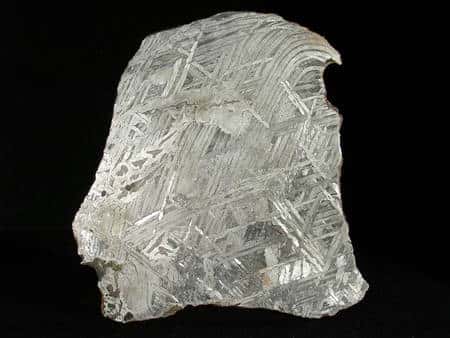 On voit ici la structure caractéristique des météorites riches en fer et en nickel dites Widmanstätten lorsqu'elles sont attaquées à l'acide. Ces sidérites sont des fragments d'astéroïdes qui eux-mêmes sont riches en métaux, dont le précieux platine. © L. Carion, www.carionmineraux.com