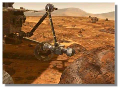 Le rover MER approche le bras articulé portant la ponceuse près de la roche à analyser. &copy; NASA / JPL