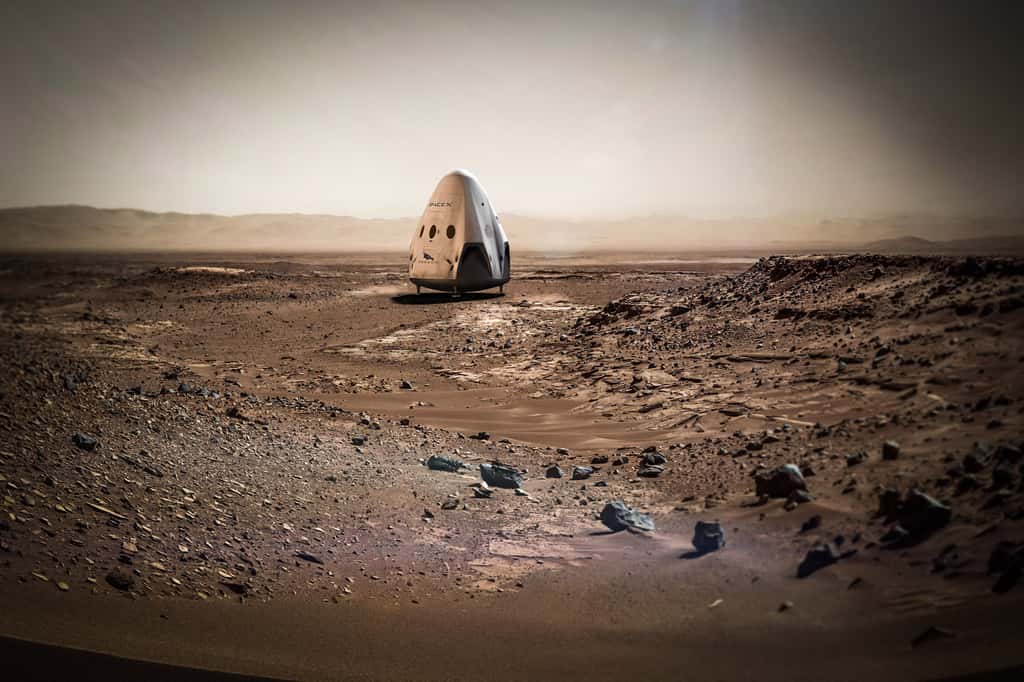 Illustration de la capsule Red Dragon, Dragon 2, venant de se poser sur Mars grâce à ses propulseurs, comme cela est prévu pour 2018. Le paysage alentour est réel : c'est celui du cratère Gale photographié par Curiosity. Ce n'est pas là, toutefois, que devrait se poser la capsule Dragon. © SpaceX, Nasa