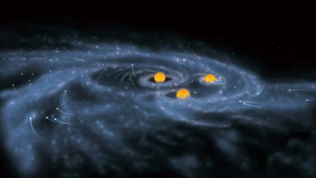 Une vue d'artiste de la simulation précédente. Trois étoiles supermassives y avalent des étoiles de masses solaires. © NAOJ