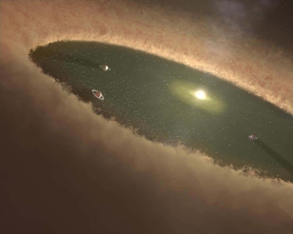 Une vue d'artiste de jeunes Jupiter chaudes plongées dans le champ de gravitation de leur soleil mais aussi du disque protoplanétaire où elles sont nées avant de migrer. Les interactions entre ce disque et les exoplanètes seraient responsables de leurs orbites très elliptiques. © Nasa