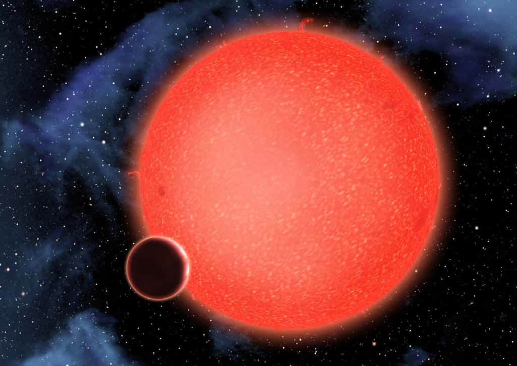 GJ 1214 b, montré dans cette vue d'artiste, est une super-Terre, ou une mini-Neptune, en orbite autour d'une étoile naine rouge à 40 années-lumière de la Terre. De nouvelles observations du télescope spatial Hubble Nasa/ESA montrent qu’il s’agit d’un monde aquatique enveloppé par une atmosphère épaisse et humide. GJ 1214 b représente un nouveau type de planète, qui ne ressemble à rien de ce que l'on voit dans le Système solaire ou dans tout autre système planétaire actuellement connu. © Nasa, ESA et D. Aguilar (Harvard-Smithsonian Center for Astrophysics)