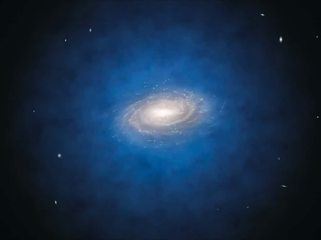 Cette vue d'artiste montre la Voie lactée. Le halo bleu de matière entourant la galaxie indique la distribution que nous imaginons de la mystérieuse matière noire, qui a été dans un premier temps introduite par les astronomes pour expliquer les caractéristiques de la rotation de la Galaxie. Aujourd'hui, cette mystérieuse matière noire est également considérée comme un composant essentiel de la théorie en vigueur sur la formation et l'évolution des galaxies. © ESO/L. Calçada