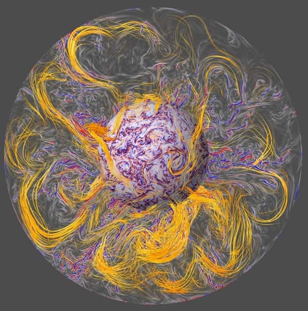 Visualisation de l’intérieur du noyau terrestre, tel que modélisé dans la simulation numérique (vue du plan équatorial et d’une surface sphérique près de la graine solide, depuis le pôle Nord). Les lignes de force du champ magnétique (en orange) sont étirées par la convection turbulente (en bleu et rouge). Les ondes hydromagnétiques sont émises depuis l’intérieur du noyau et se propagent le long des lignes de force du champ, jusqu’à la surface du noyau où elles se focalisent pour créer des secousses géomagnétiques.<br />© Aubert et al./IPGP/CNRS Photothèque