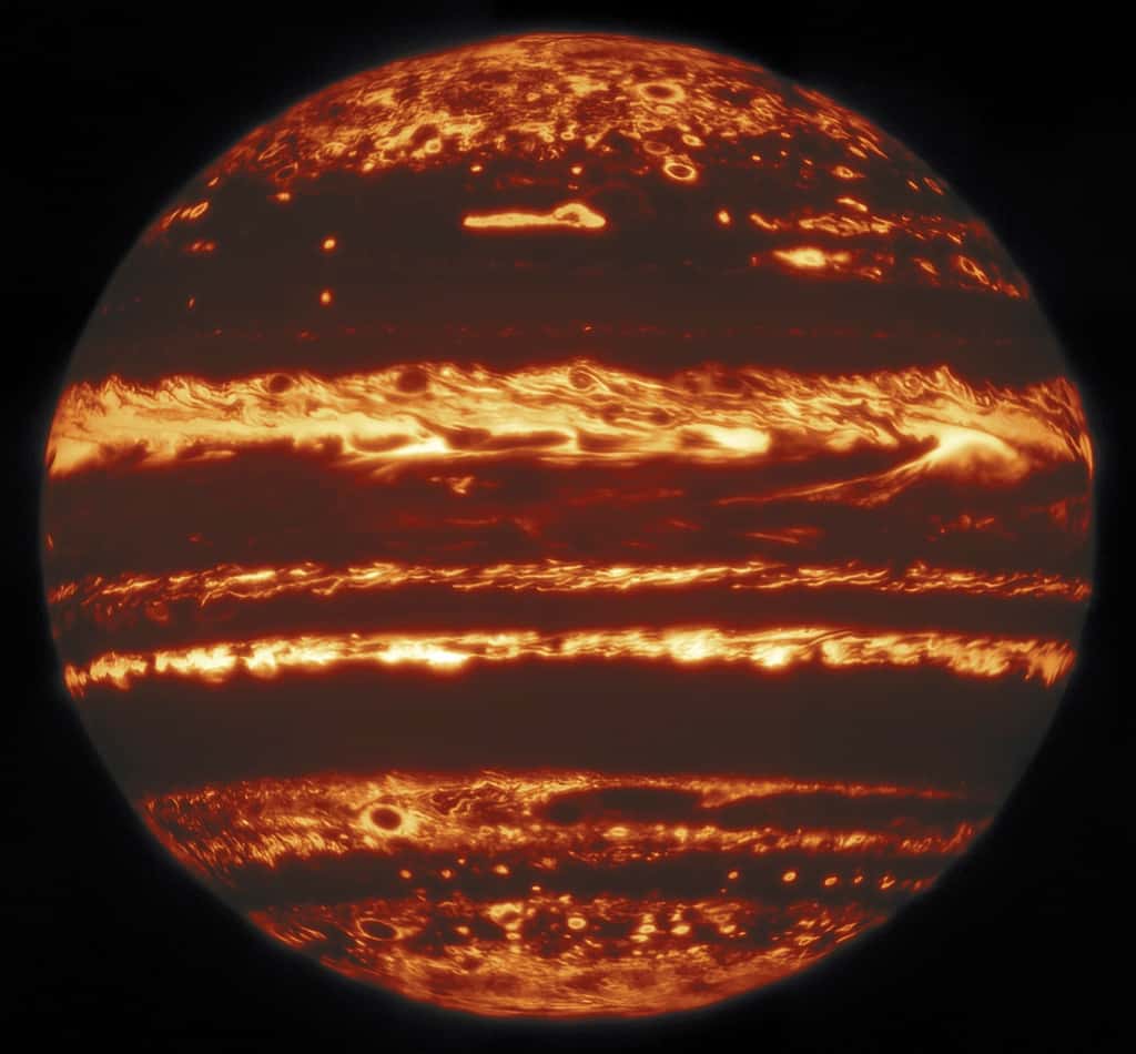 Jupiter vue en infrarouge par l'observatoire Gemini. Cette image a été compilée à partir d'une mosaïque de 9 pointages réalisés le 29 mai 2019. Chaque pointage consistait en 38 poses d'<em>« imagerie chanceuse »</em>, dont les 10 % des meilleures furent conservées pour chaque neuvième du disque de Jupiter. Bien que la prise de chaque image ne prenne que quelques secondes, les 38 poses d'un pointage peuvent prendre plusieurs minutes, ce qui est suffisant pour que certaines structures se déplacent de façon notable sur le disque. Pour comparer et combiner les images, elles sont d'abord associées à leurs latitude et longitude réelles sur la planète en utilisant le bord du disque comme référence. Les images finales ont une résolution parmi les meilleures jamais obtenues en infrarouge de Jupiter depuis le sol. © International Gemini Observatory, NOIRLab, NSF, AURA, M.H. Wong (UC Berkeley)