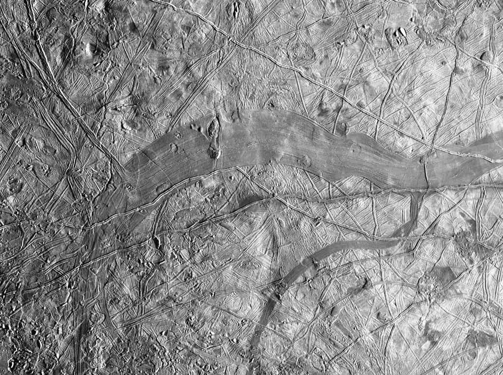 Cette image a été prise non loin de l'équateur d'Europe. Elle montre environ 135 kilomètres carrés de la lune glacée de Jupiter. Une bande grise se détache clairement. Il s'agit de Phaidra Linea, qui montre que la banquise d'Europe a été déchirée à cet endroit. Certaines structures se correspondent de part et d'autre de la région occupée par de nouveaux matériaux. L'ensemble fait irrésistiblement penser à l'expansion des fonds océaniques sur Terre. © Nasa, JPL