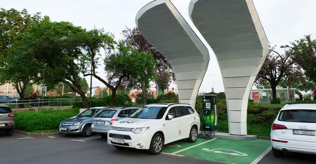 Des bornes de chargement pour véhicule électrique pourraient être directement reliées à des panneaux solaires installés en couverture des parkings. © scharfsinn86, Adobe Stock
