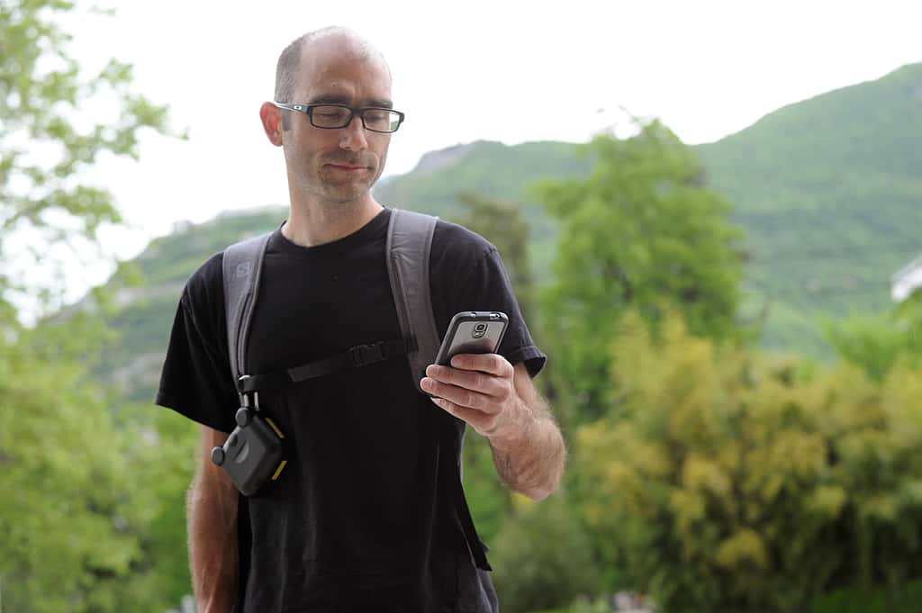 Une application sur smartphone interroge le capteur porté en bandoulière et montre une analyse rapide de l'air ambiant. © Jean-Pierre Clatot, AFP Photo