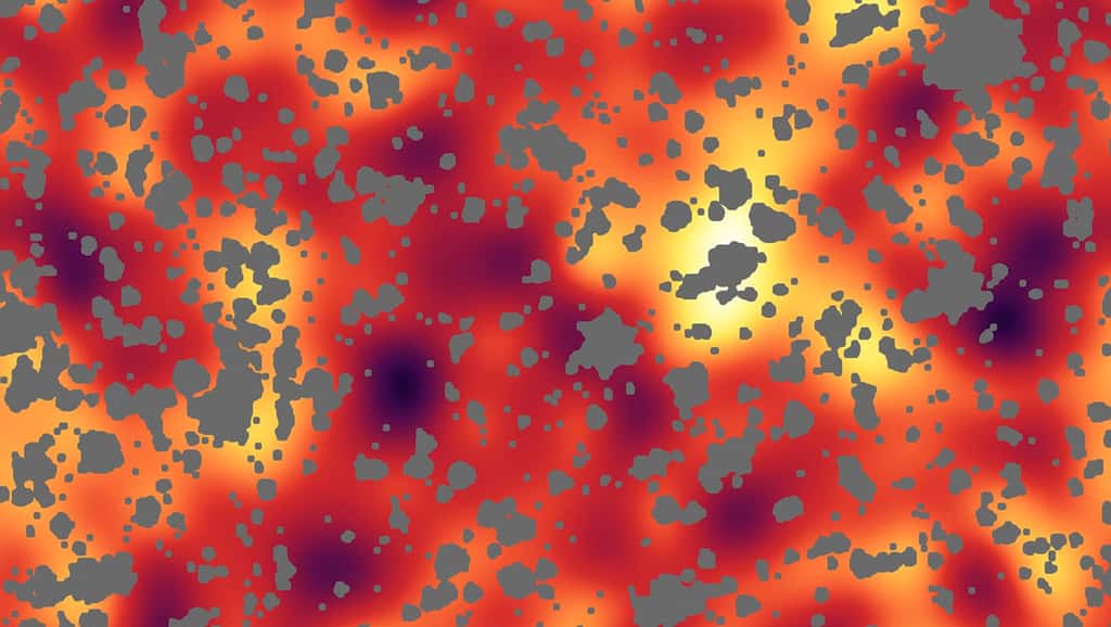 Les irrégularités remarquées dans le fond diffus infrarouge (cosmic infrared background) dans cette région du ciel pourraient être liées aux premiers objets lumineux de l’Univers, moins d’un milliard d’années après le Big Bang. Les taches grises correspondent aux objets connus au premier plan (étoiles, galaxies, nuages de gaz, de poussière…) qui ont été retirés. © Nasa, JPL-Caltech, A. Kashlinsky (Goddard)