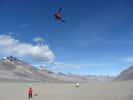 Sur le site Bull Pass, dans la vallée Wright, l'une des vallées sèches de McMurdo, en Antarctique, un hélicoptère emporte le capteur aéroporté électromagnétique (ou AEM pour airborne transient electromagnetic, en anglais). L'engin a été conçu par l'université danoise d'Aarhus avec l'entreprise SkyTem. Il permet de dresser des cartes des réseaux aquifères. Sur ce continent du pôle Sud, il a décelé un grand nombre de poches de saumure dans le sous-sol ou sous la glace. © Jill Mikucki