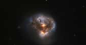 Sur cette image en fausses couleurs (la rouge correspond à l'infrarouge et les autres au visible), on voit la source infrarouge IRAS 16399-0937 observée par Hubble. Il s'agit de deux galaxies en cours de fusion après une collision. Elles sont le siège d'un mégamaser. © ESA, Hubble &amp; Nasa, Judy Schmidt
